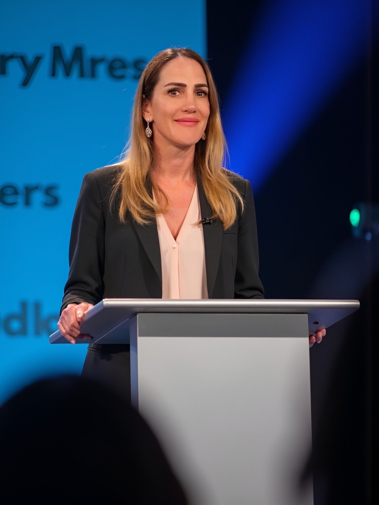 Skye Butler speaking on stage at a keynote event